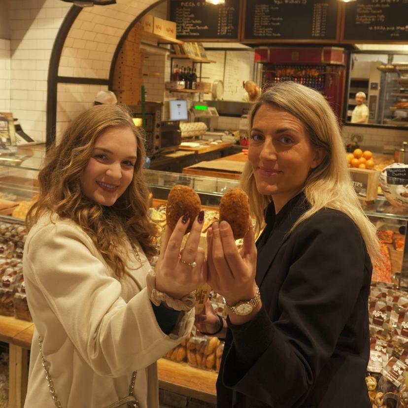 Guests enjoying freshly made supplì during the Trastevere Evening Stroll food experience