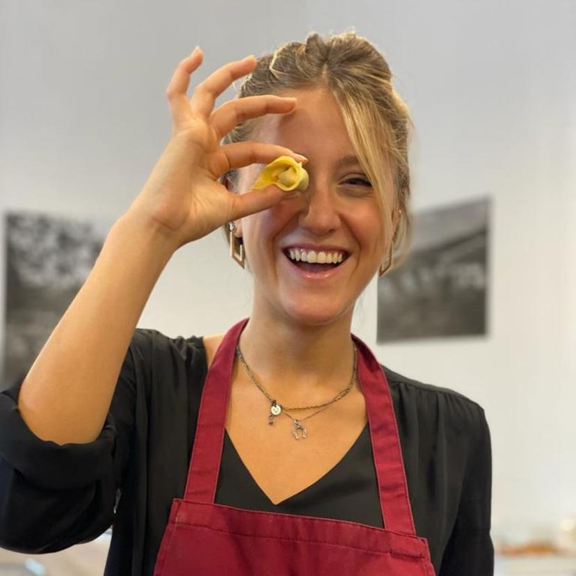Girl enjoying a hands-on pasta making class at InRome Cooking