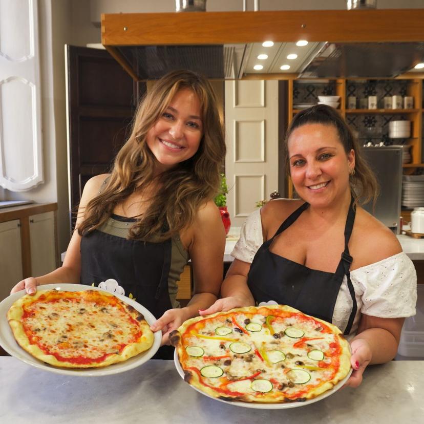 Homemade pizzas from the Pizza Making class & gelato Women holding their homemade pizzas from the Pizza Making class & gelato at InRome Cooking